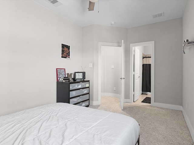 bedroom featuring baseboards, visible vents, ceiling fan, and light colored carpet