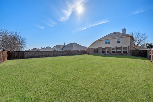 view of yard with a fenced backyard