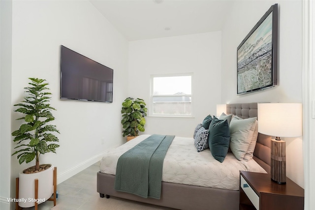 bedroom with light wood finished floors and baseboards