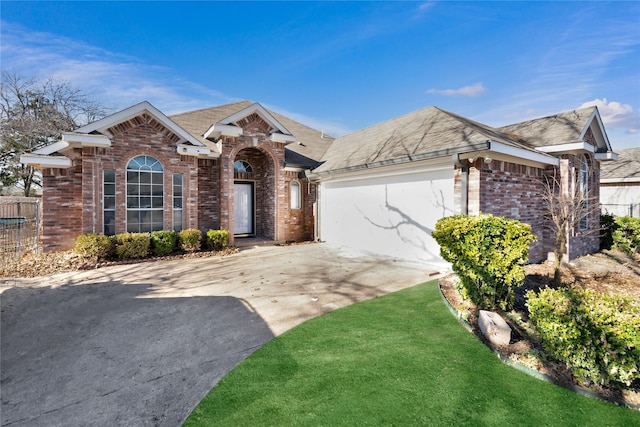 ranch-style house with a front yard and a garage