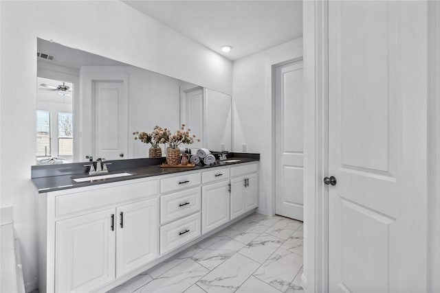 full bathroom featuring double vanity, marble finish floor, visible vents, and a sink