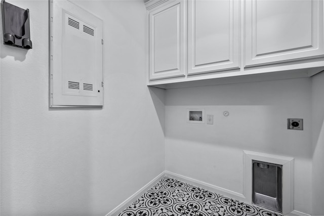 laundry area with gas dryer hookup, hookup for an electric dryer, washer hookup, baseboards, and cabinet space