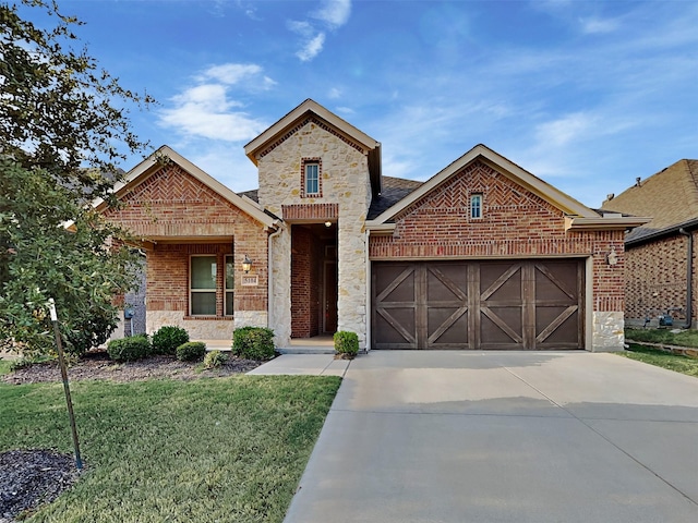 view of front of house with a garage and a front lawn