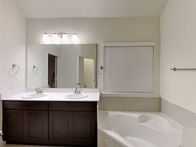 bathroom with vanity and a relaxing tiled tub