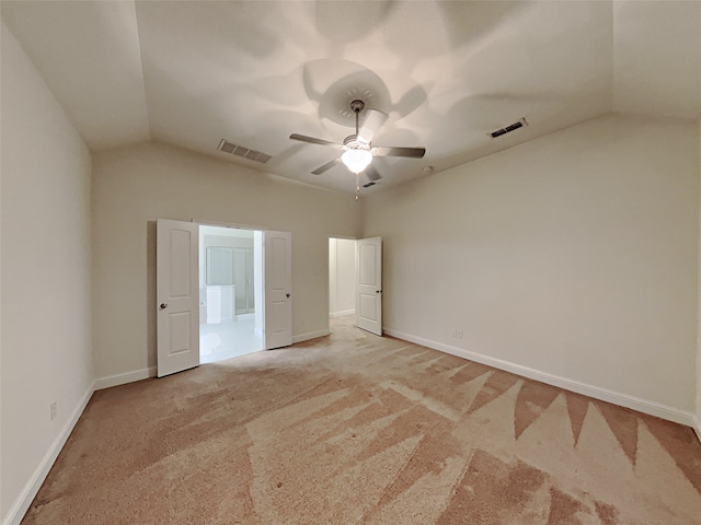 unfurnished bedroom featuring ceiling fan, light carpet, and lofted ceiling