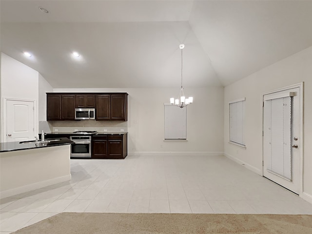 kitchen with appliances with stainless steel finishes, sink, an inviting chandelier, decorative light fixtures, and dark brown cabinetry