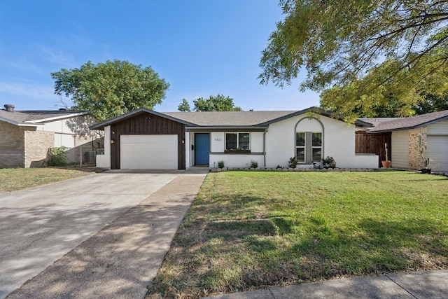 ranch-style house featuring a front yard and a garage