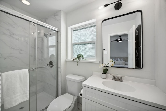 bathroom featuring toilet, vanity, and a shower with shower door