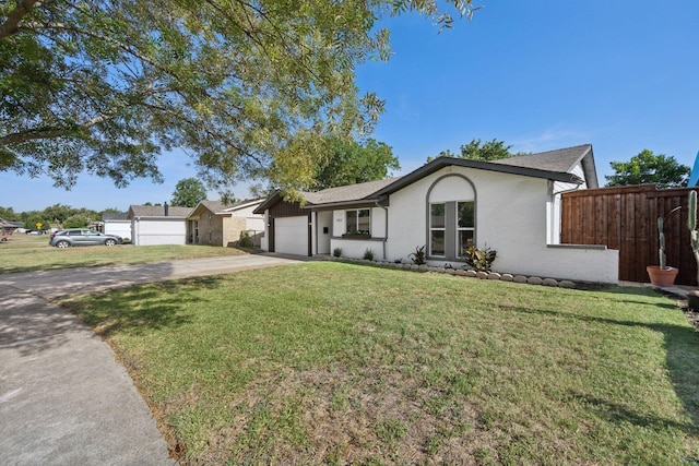 ranch-style home with a front lawn and a garage