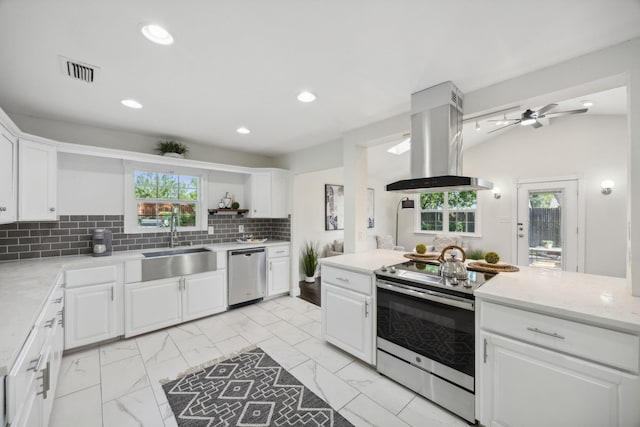 kitchen featuring stainless steel appliances, white cabinetry, and island exhaust hood