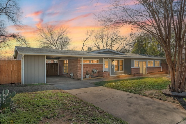 view of front facade featuring a carport and a lawn