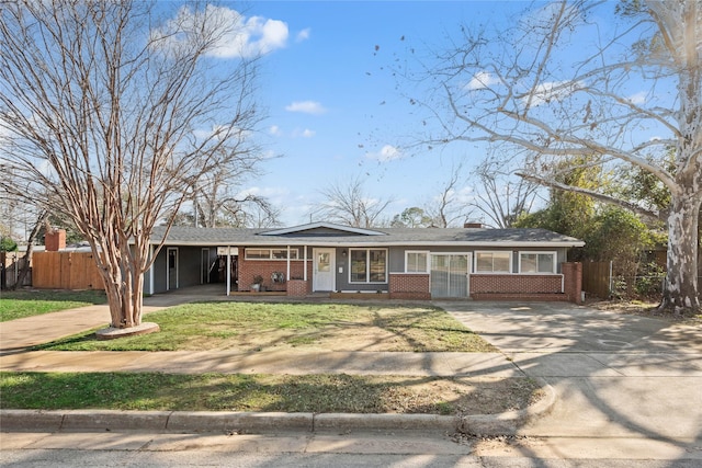 ranch-style home with a front lawn and a carport