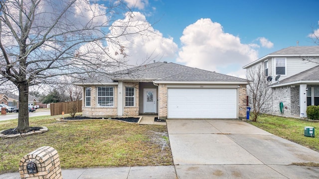 view of front of home with a front yard and a garage