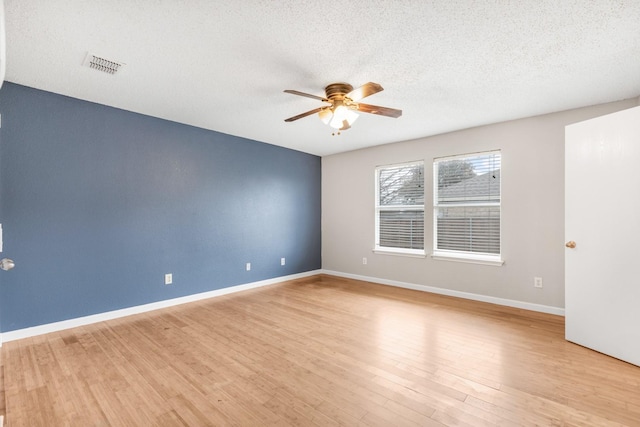 spare room featuring a textured ceiling, ceiling fan, and light hardwood / wood-style flooring