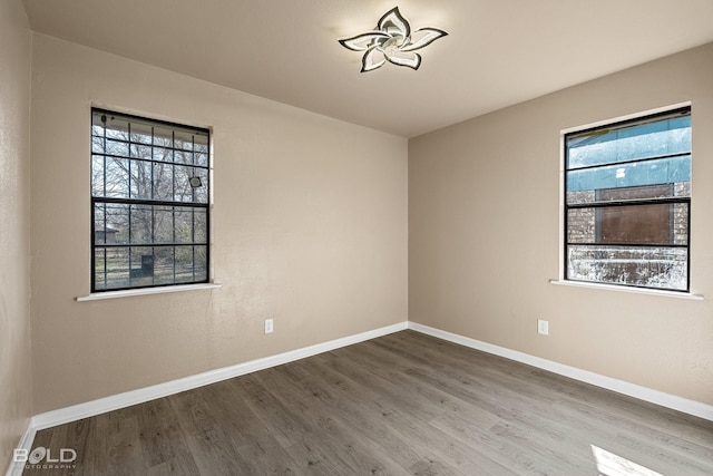 unfurnished room featuring hardwood / wood-style flooring