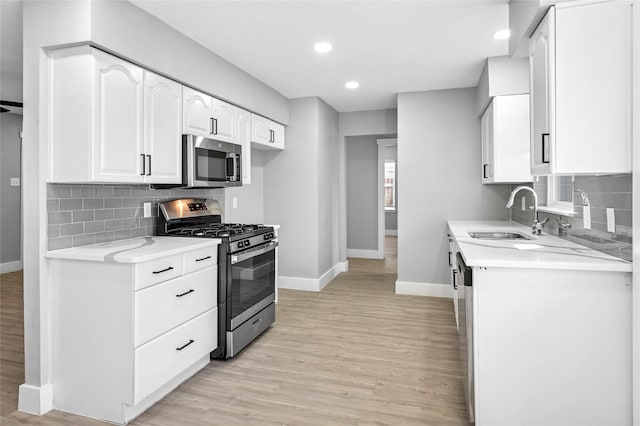 3126 Colchester Dr, Farmers Branch, TX 75234 - kitchen featuring appliances with stainless steel finishes, baseboards, a sink, light wood-type flooring, and recessed lighting