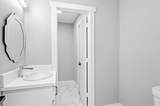 bathroom featuring toilet and vanity