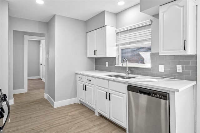 kitchen featuring sink, light wood-type flooring, white cabinetry, dishwasher, and tasteful backsplash