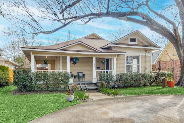 view of front of home with a front yard and covered porch