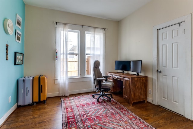 office with dark wood-style floors and baseboards