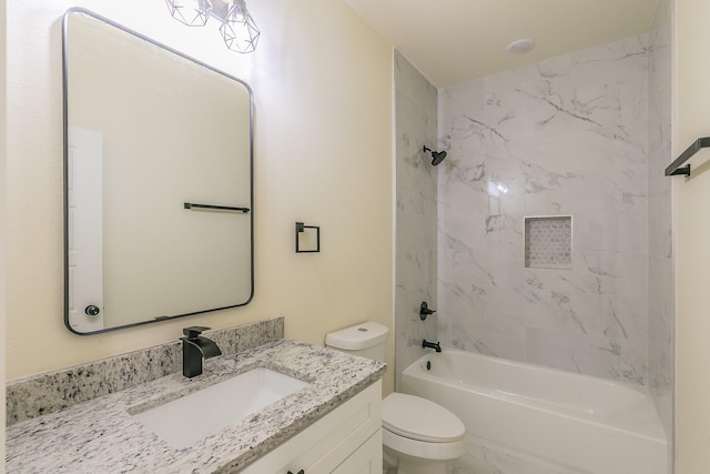 full bathroom with toilet, vanity, and tiled shower / bath combo