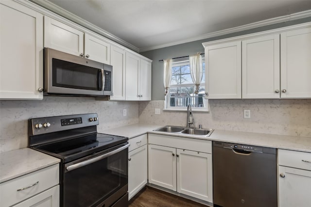 kitchen with appliances with stainless steel finishes, sink, and white cabinetry