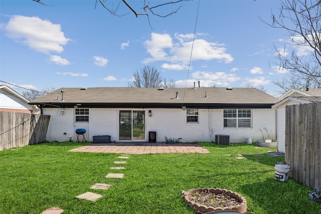 rear view of house featuring a yard, a patio, and central AC