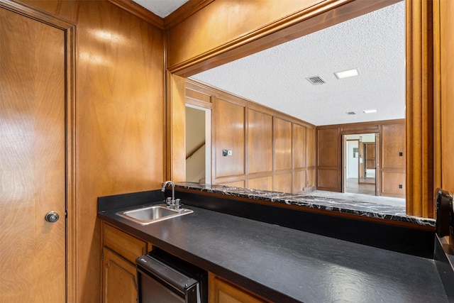 kitchen featuring sink and a textured ceiling