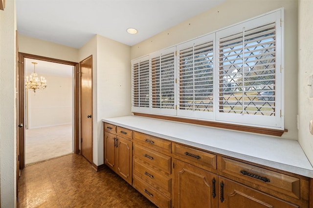 interior space with decorative light fixtures, an inviting chandelier, dark parquet flooring, and a wealth of natural light