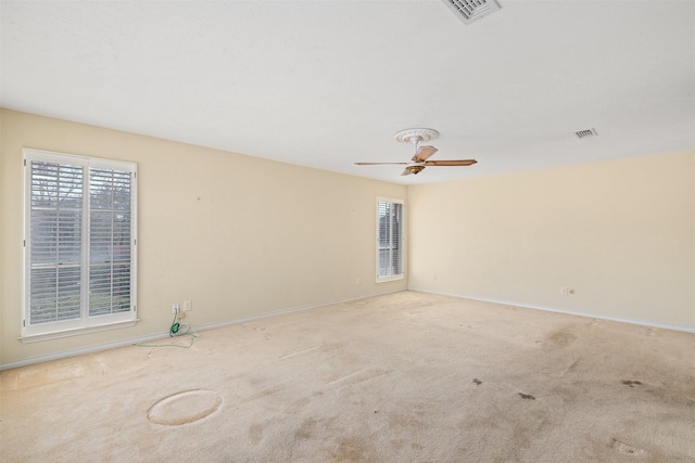 carpeted spare room with ceiling fan