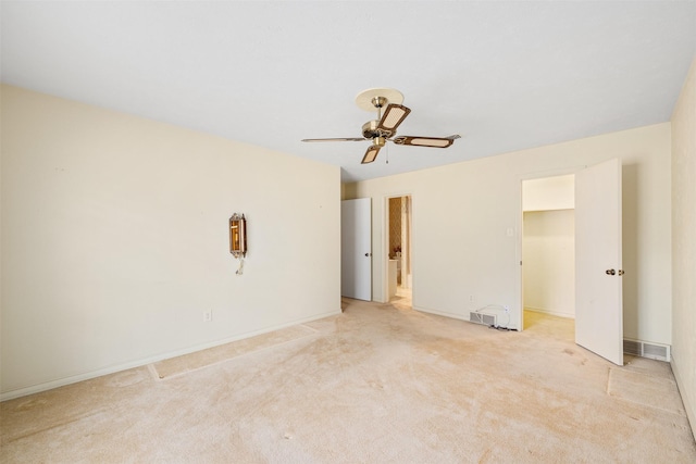 spare room with light carpet and ceiling fan