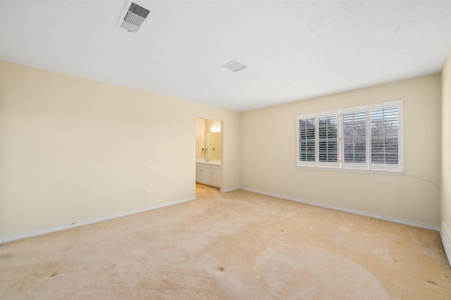 empty room featuring light colored carpet