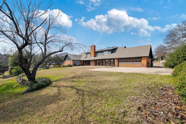 exterior space featuring a garage and a lawn