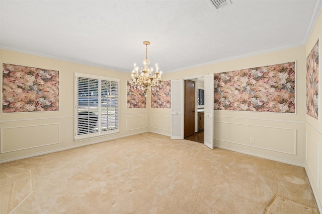 carpeted spare room featuring crown molding and an inviting chandelier