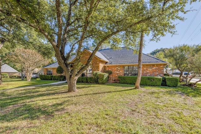 ranch-style house with brick siding and a front yard