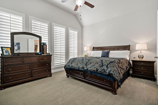 bedroom featuring ceiling fan, vaulted ceiling, and light carpet