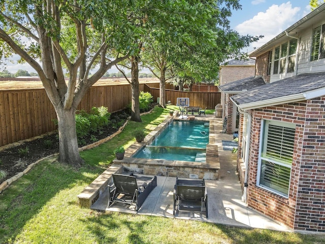 view of swimming pool featuring a patio area and a yard