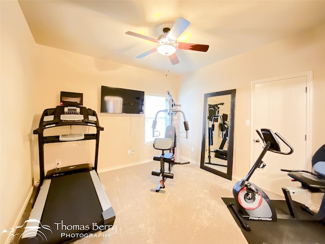 exercise area with carpet floors, a ceiling fan, and baseboards