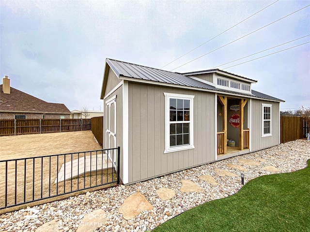 view of outbuilding featuring an outdoor structure and fence