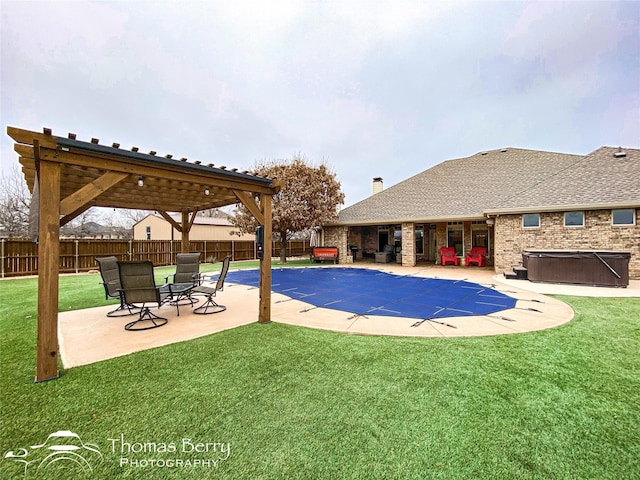 view of swimming pool featuring a yard, a fenced backyard, a patio, and a hot tub