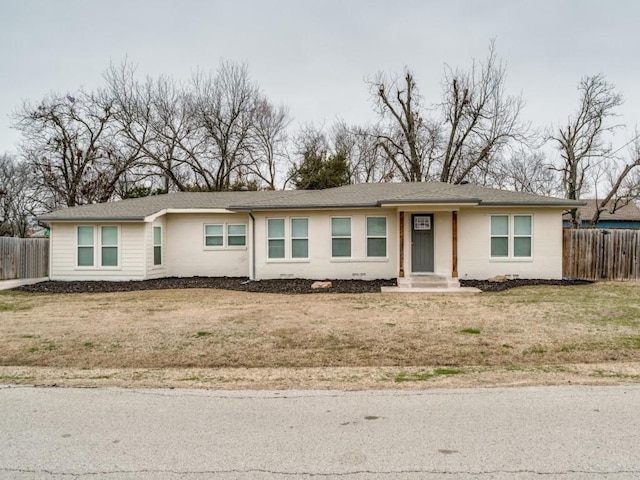 single story home with fence and a front yard