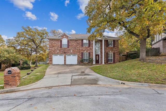 view of front of property featuring a front yard and a garage