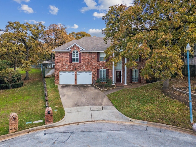 view of front of property with a front lawn and a garage