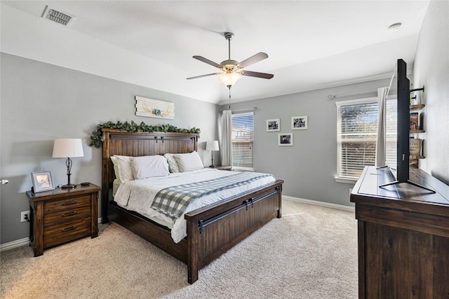 bedroom featuring light carpet, ceiling fan, visible vents, and baseboards