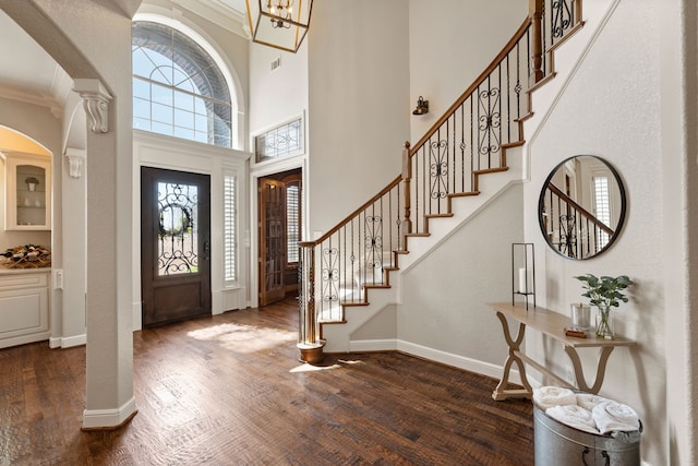 entrance foyer with a healthy amount of sunlight, baseboards, and dark wood finished floors