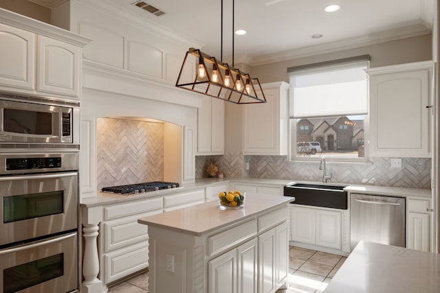 kitchen featuring a sink, visible vents, appliances with stainless steel finishes, decorative backsplash, and crown molding