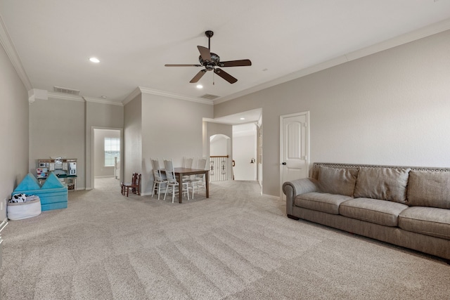 unfurnished living room with carpet floors, arched walkways, crown molding, recessed lighting, and visible vents