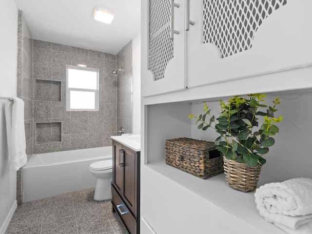 full bathroom featuring tiled shower / bath combo, vanity, toilet, and tile patterned flooring