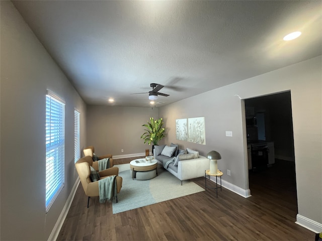 living area featuring dark wood-style flooring, recessed lighting, ceiling fan, a textured ceiling, and baseboards