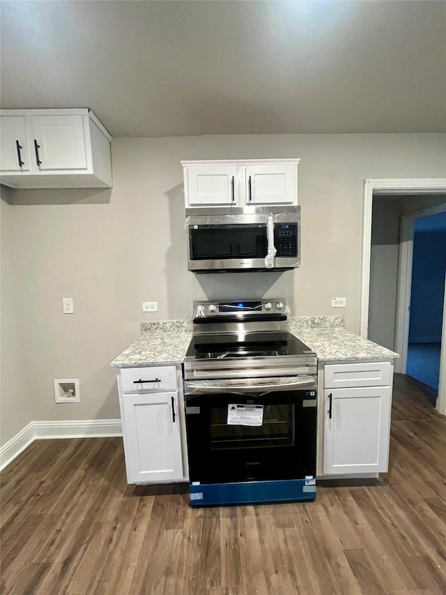 kitchen with baseboards, white cabinetry, stainless steel appliances, and dark wood-style flooring